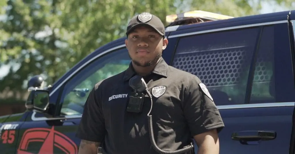 silbar security guard standing in front of a patrol car