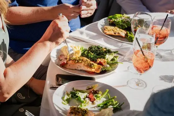 A guest holding a specialty cocktail during full bar service at a Monte Sereno backyard wedding catered by Handheld Catering