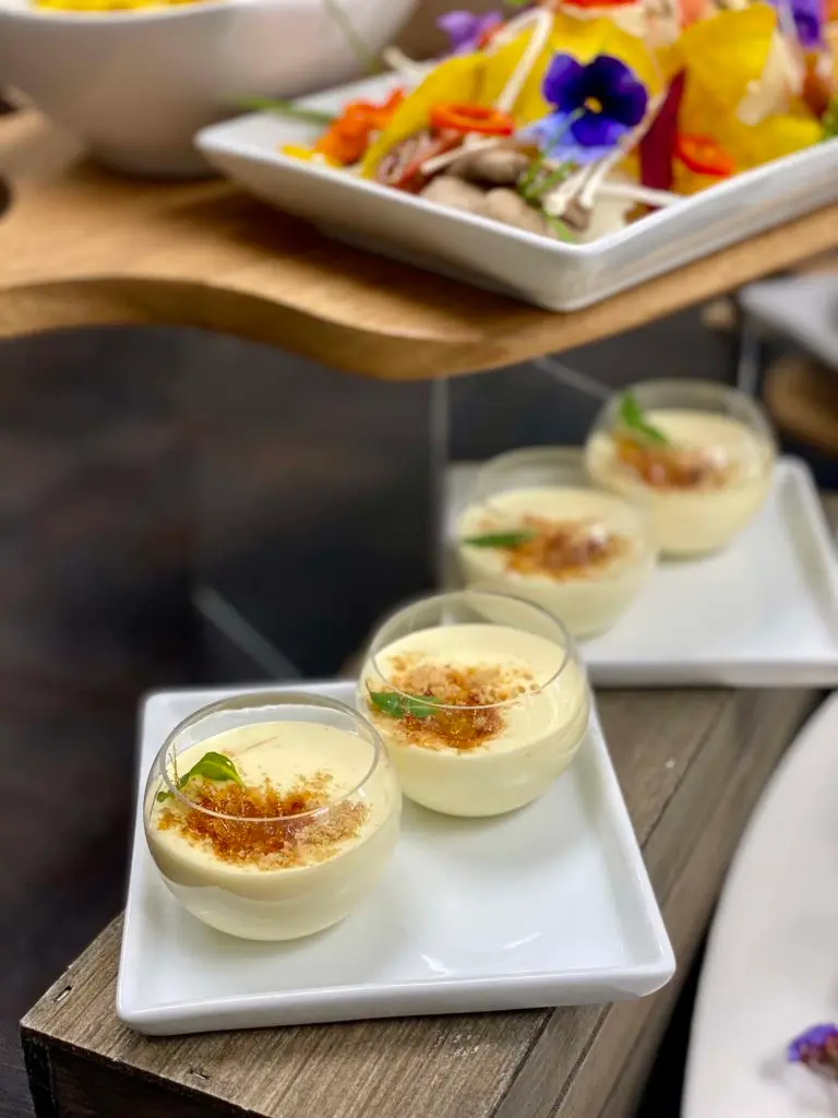 Individual creme brulee desserts on a Handheld Catering dessert station