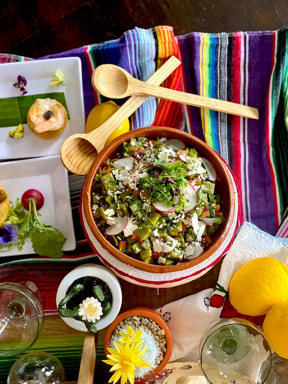 Build-your-own taco bar salad bowl with toppings on a striped serape
