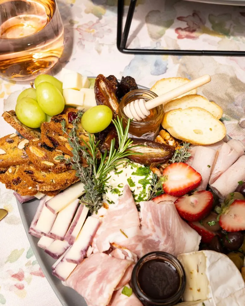 Handheld Catering farm-to-fork seasonal grazing board with artisan cheeses, fresh fruit and rose wine — Silicon Valley catering
