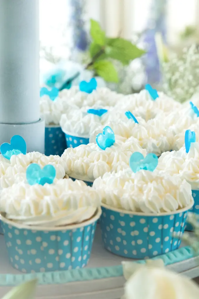 Frosted cupcakes with blue sugar hearts
