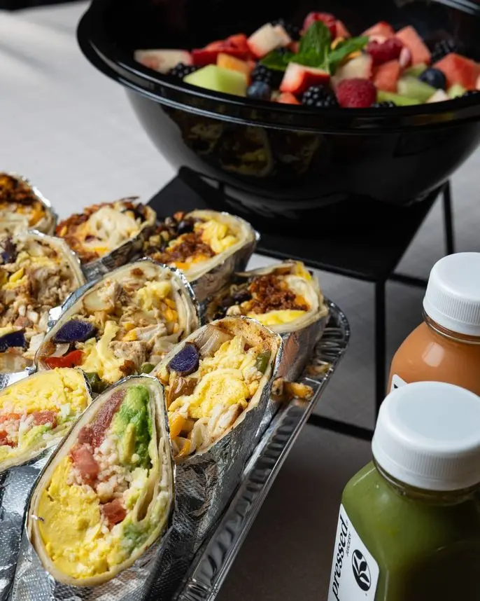 Breakfast burritos with fresh fruit bowl and cold-pressed juices, Handheld Express delivery
