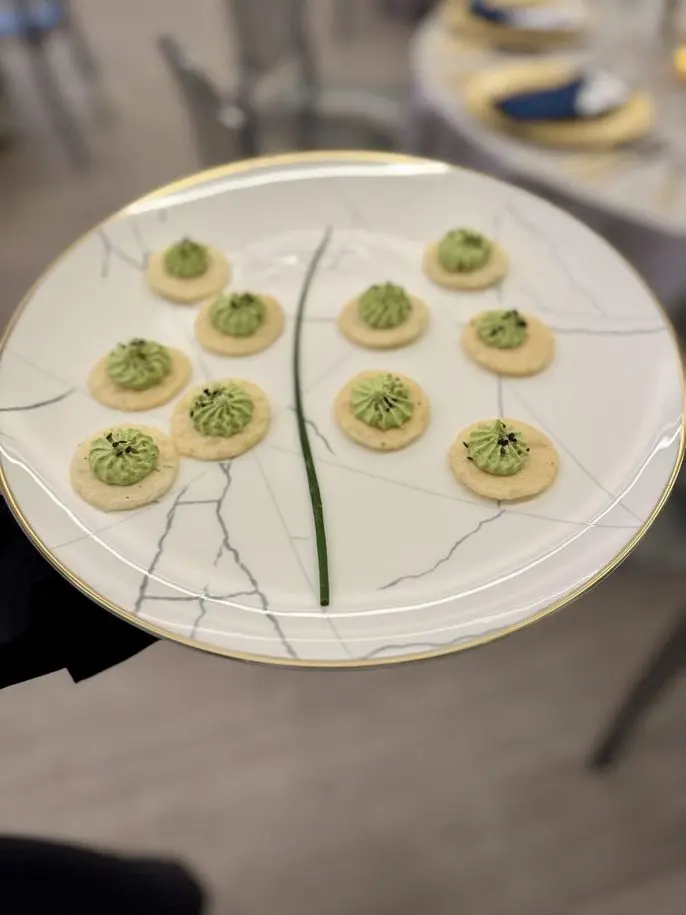 Vegan edamame hummus on rice crackers with lemon zest and za'atar, passed hors d'oeuvres by Handheld Catering