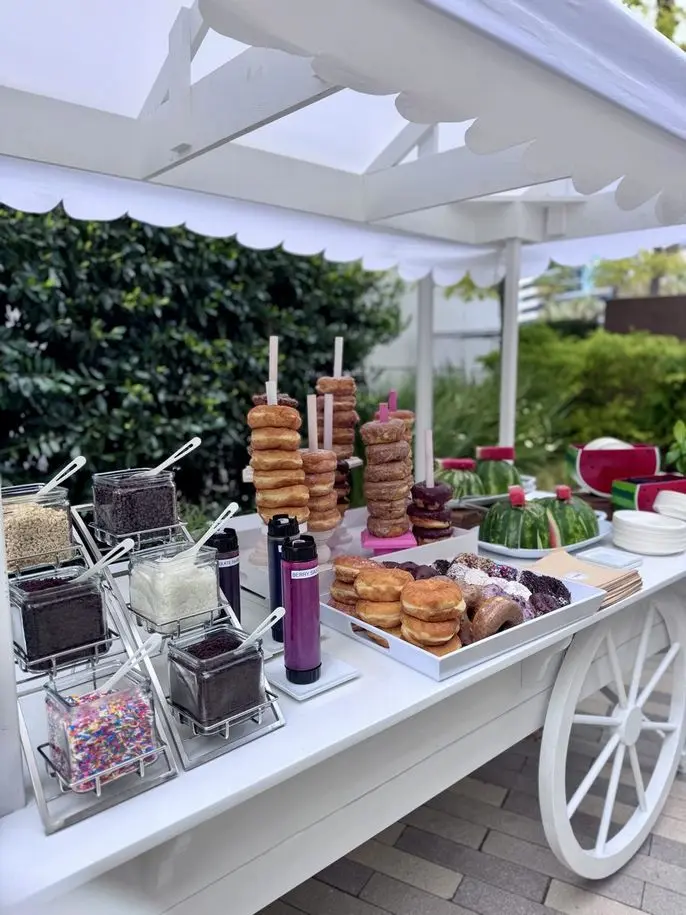 Interactive donut cart station with toppings and glazes at a Silicon Valley team-building event