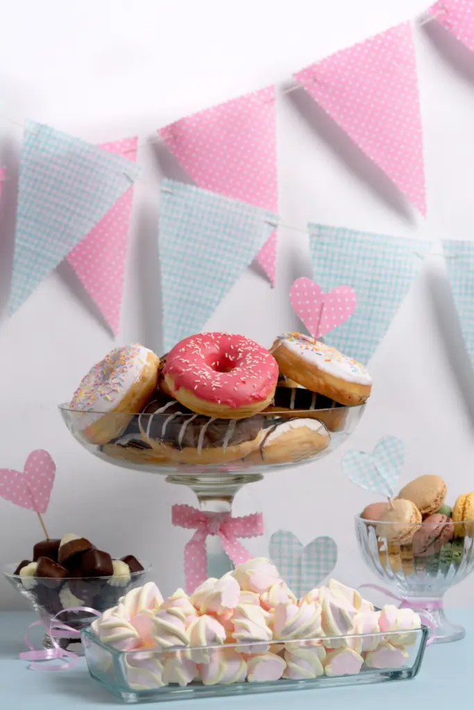 Donut and dessert station with pastel bunting for a party