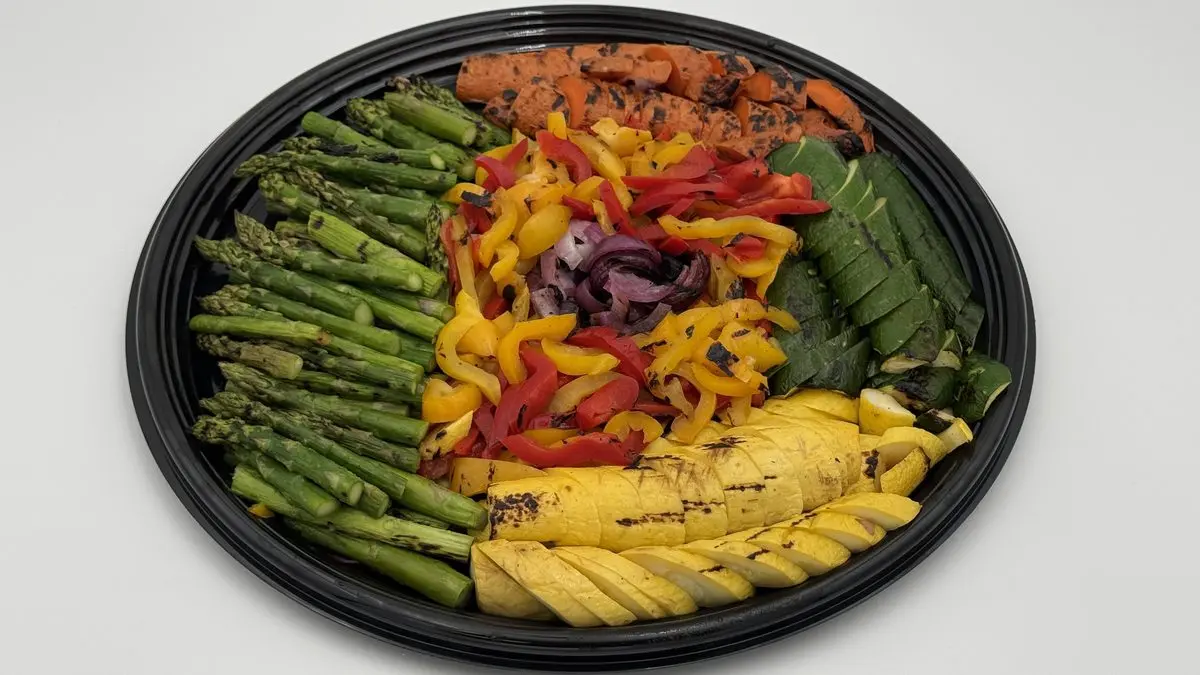 Colorful grilled vegetable platter with asparagus, bell peppers, zucchini, and squash by Handheld Catering