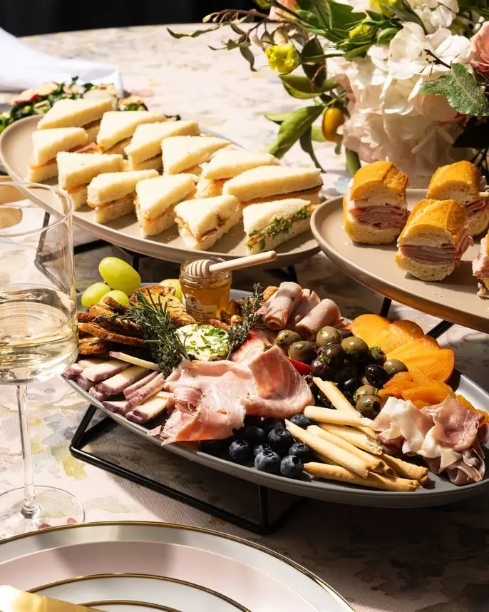Tea sandwiches, mini jambon beurre on baguette, and charcuterie spread for a birthday celebration