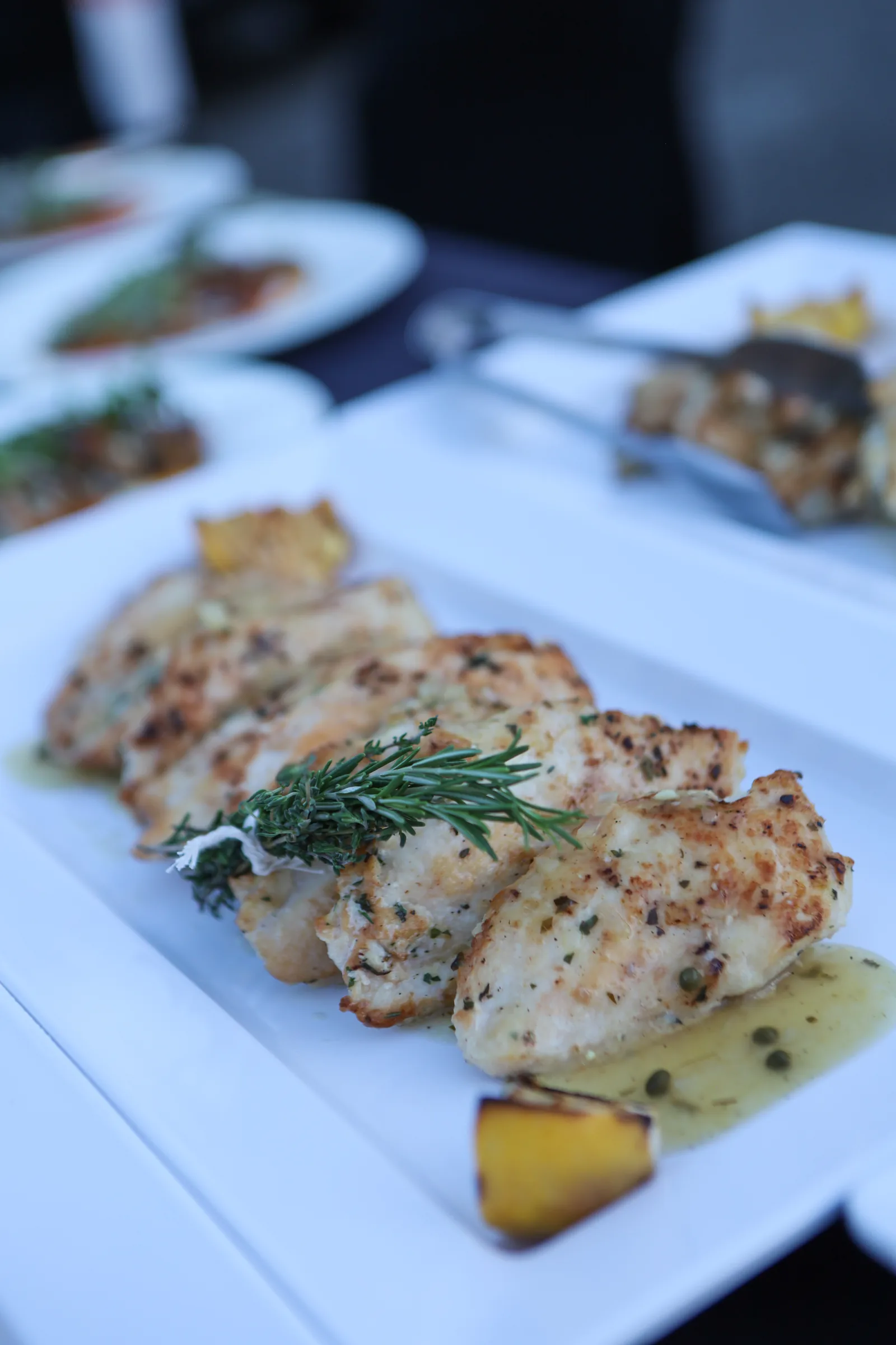 Pan-seared chicken piccata with lemon caper sauce and fresh rosemary garnish served at the History Park San Jose fundraising gala