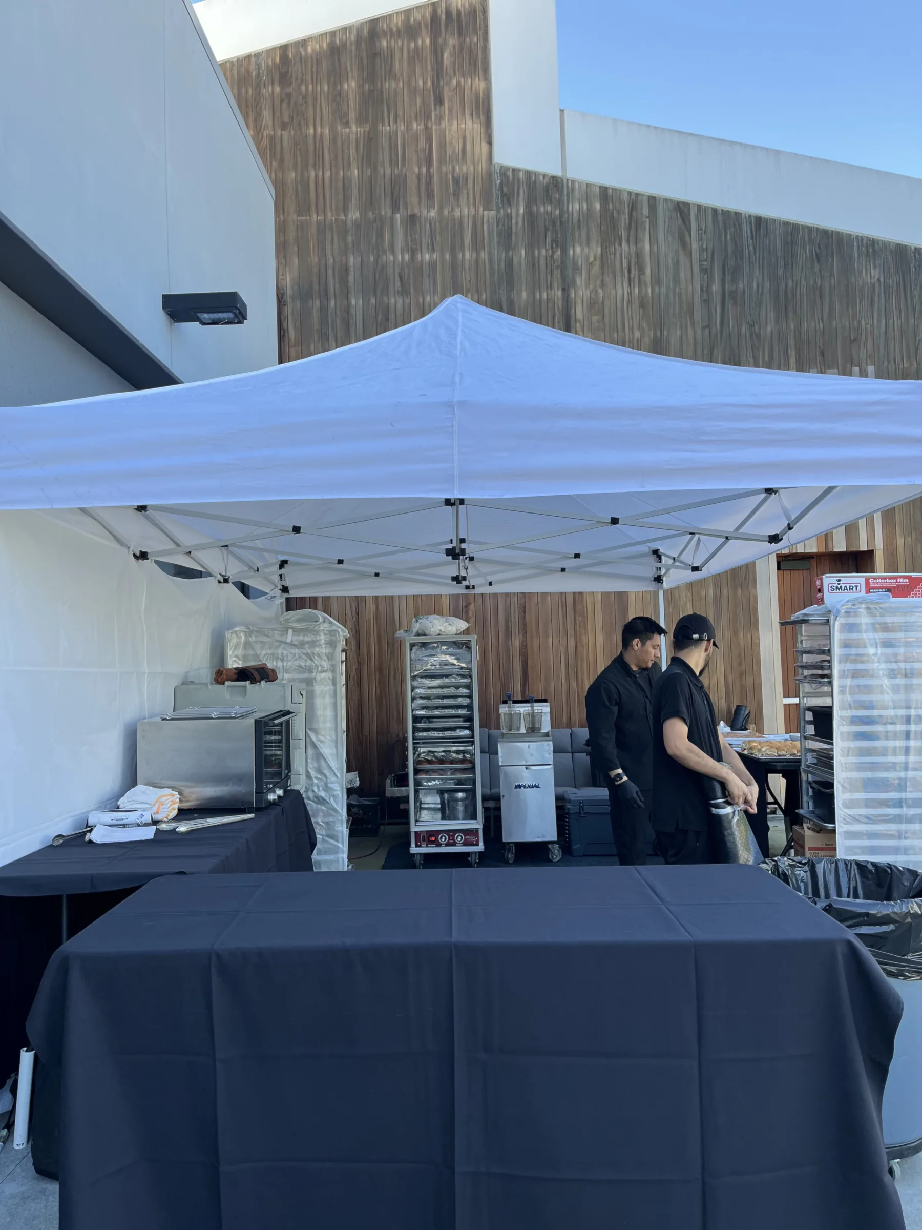 Handheld Catering outdoor pop-up field kitchen tent set up at Silicon Valley corporate campus for March Madness tailgate event