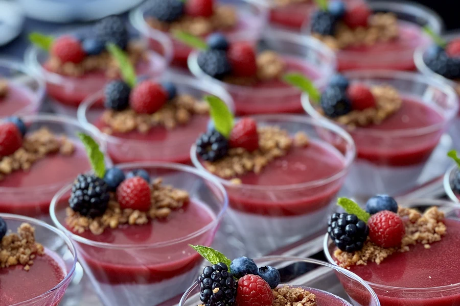 Berry mousse dessert cups with fresh berries and granola prepared by Handheld Catering for a Bay Area reception