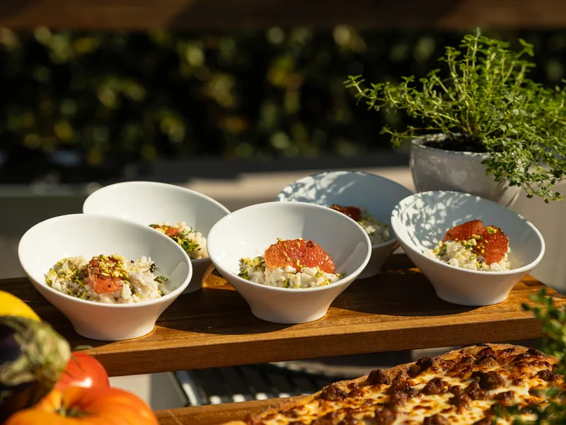 Risotto stations served buffet-style at an outdoor Silicon Valley reception by Handheld Catering