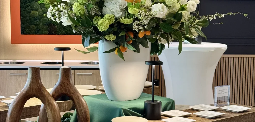 Handheld Catering buffet display with wood and gold accents and branded florals at a Santa Clara headquarters grand opening.