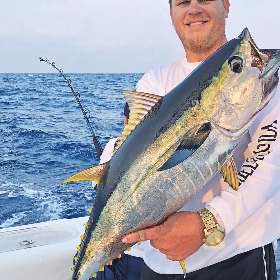 Man Holding a Fish on Boat