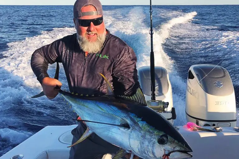 Man Displaying a Big Yellow Fin Fish on Boat