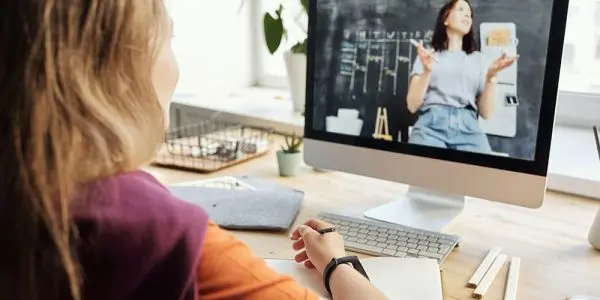 Kid attending a virtual class on laptop