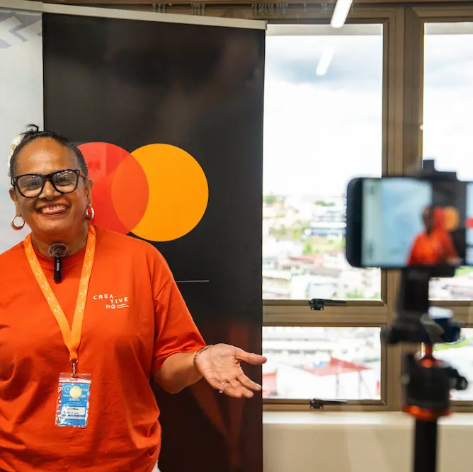 Woman smiling talking in front of a camera