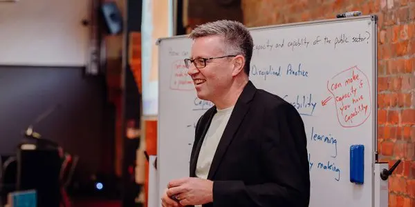 Man in front of whiteboard