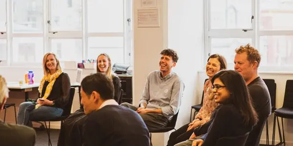 Creative HQ's startup founders sitting and laughing during a workshop