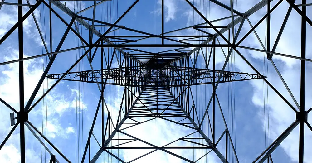 Metal transmission tower underneath