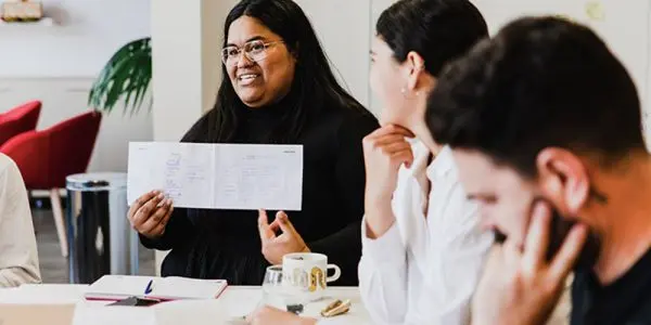 Woman holding paper in workshop