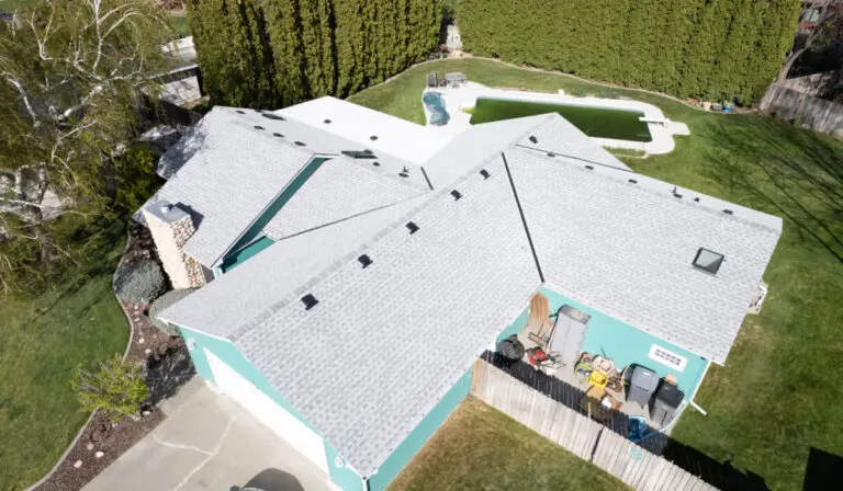 bright blue home with light gray roof from overhead