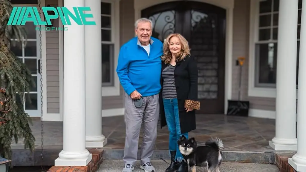 Happy Alpine Roofing customers standing in front of their home in Tri-Cities, WA