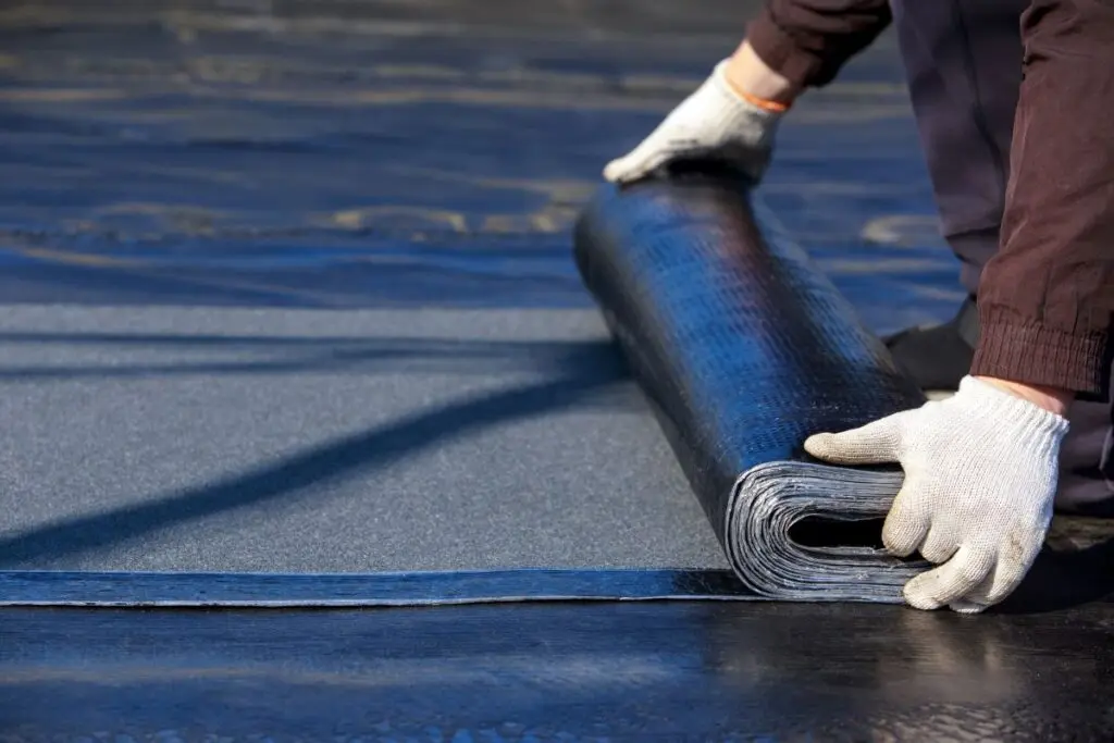 residential flat roof worker replacing bitumen