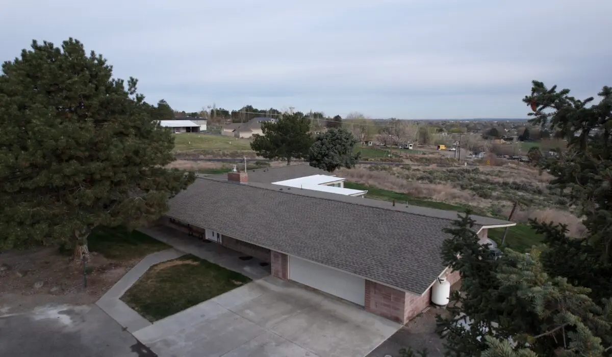 brick home with brown shingle roof in kennewick washington