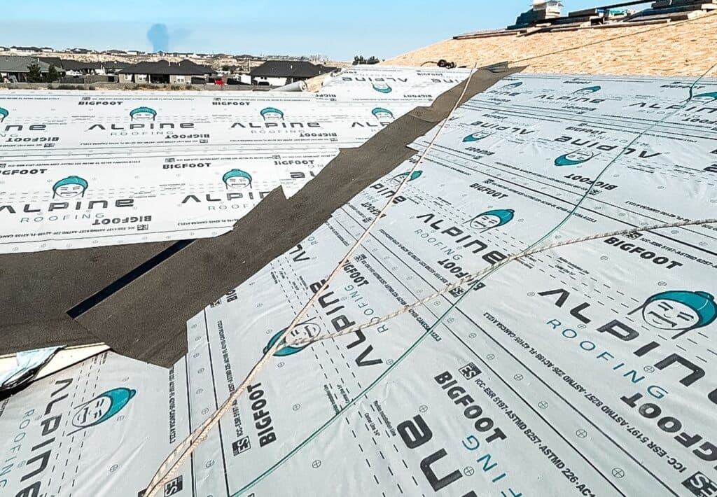 Roof replacement showing the logo of Alpine Roofing