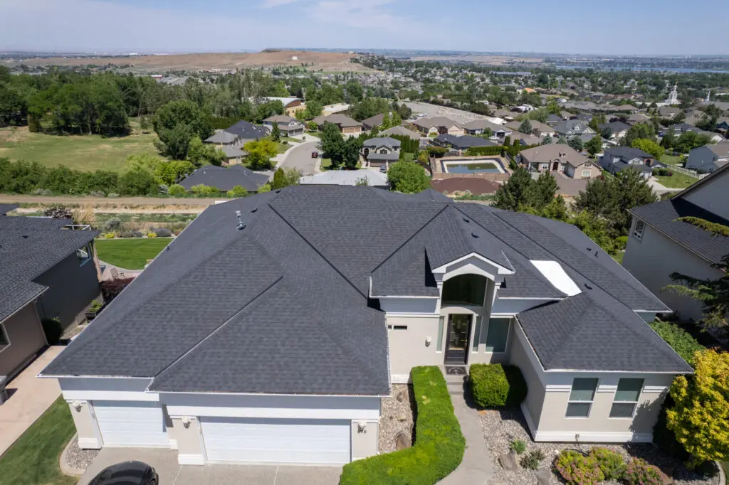 lovely large home with black shingle roof from overhead