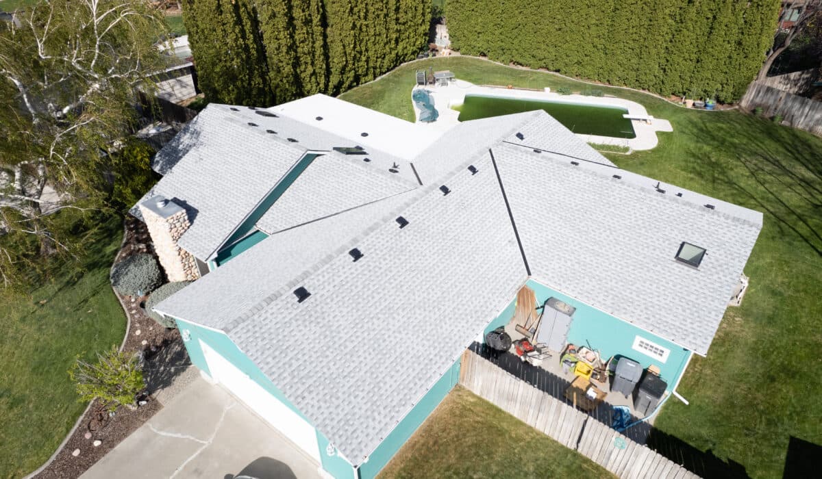 bright blue home with light gray roof from overhead