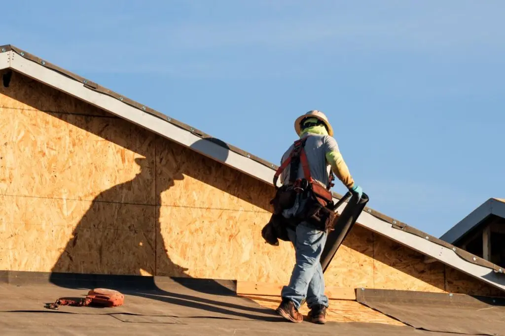 roofing companies in Sandpoint ID worker installing new roof
