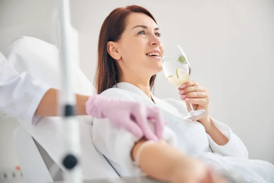 Woman smiling while receiving IV therapy to boost immunity.