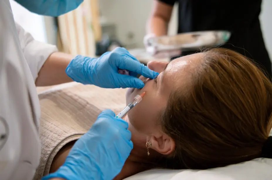 Professional treating a client with cosmetic injectables for a refreshed, new look.