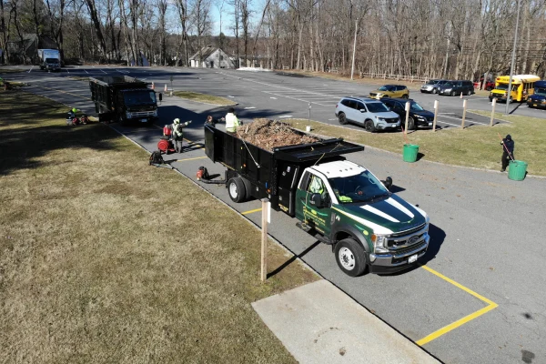 Seasonal yard cleanup service removing leaves, branches, and landscape debris