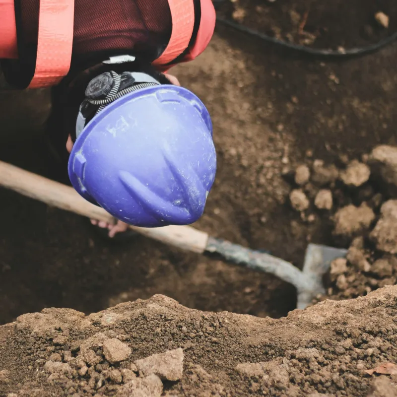 man using a shovel to dig