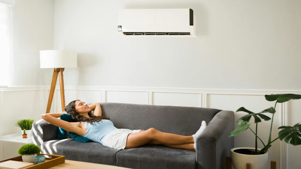 woman chilling on couch under aircon