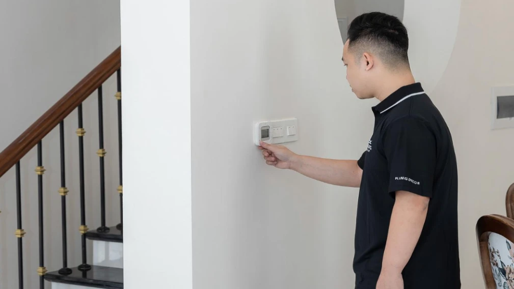 Homeowner adjusting thermostat during regular HVAC system use