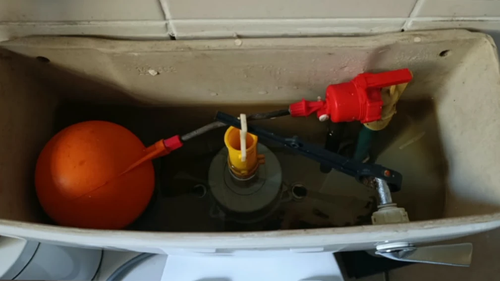 a close-up view of a toilet's chain connection