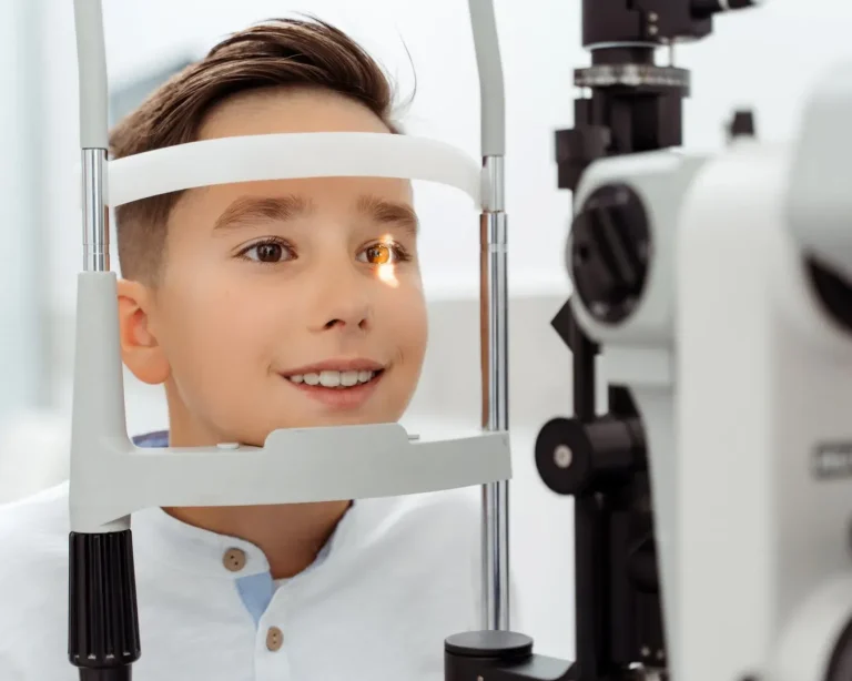 Pediatric optometrist examining a child in a friendly clinic