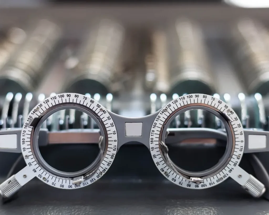 Close-up of eyeglasses, contact lenses, and an eye chart, representing myopia management options