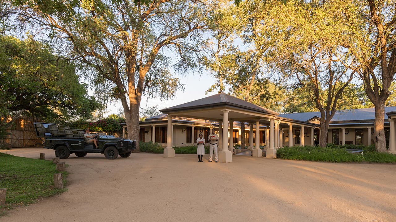 Mala-Mala game reserve luxury accommodation with 2 butlers standing at the entrance.