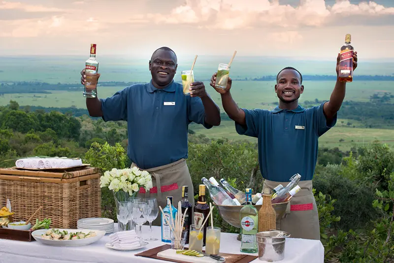 Sundowners with private butlers on deck with view at andBeyond Bateleur Camp, an exclusive luxury safari experience