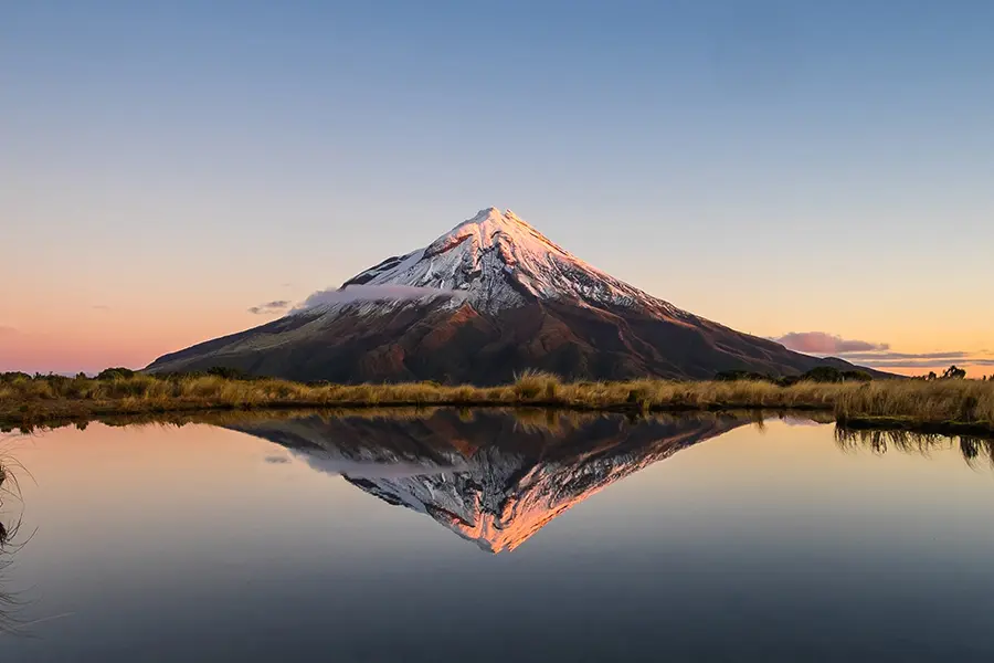 Stunning view of a snow peaked Kilimanjaro across a lake while on a luxury safari tour