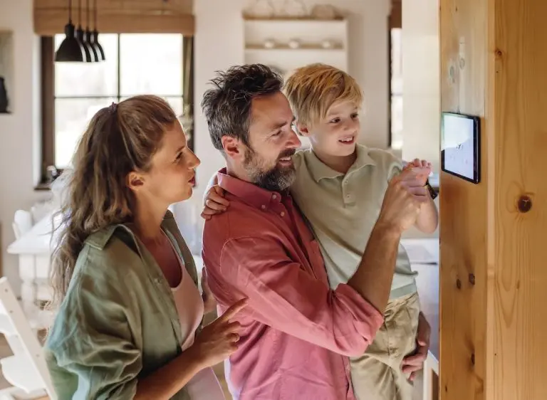 Family looking at smart thermostat