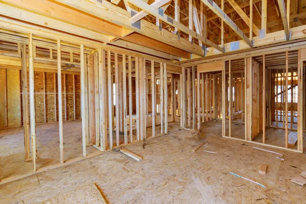 Interior wood framing and wall studs of house under construction