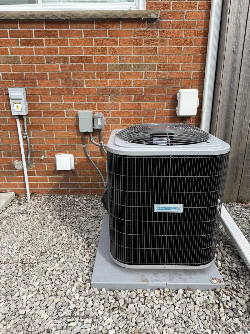 ac condenser beside brick building