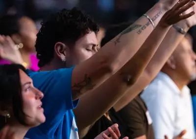 man, hands raised worshipping