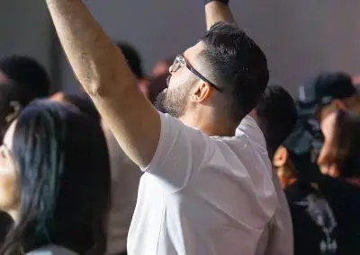 man raising his hands in worship